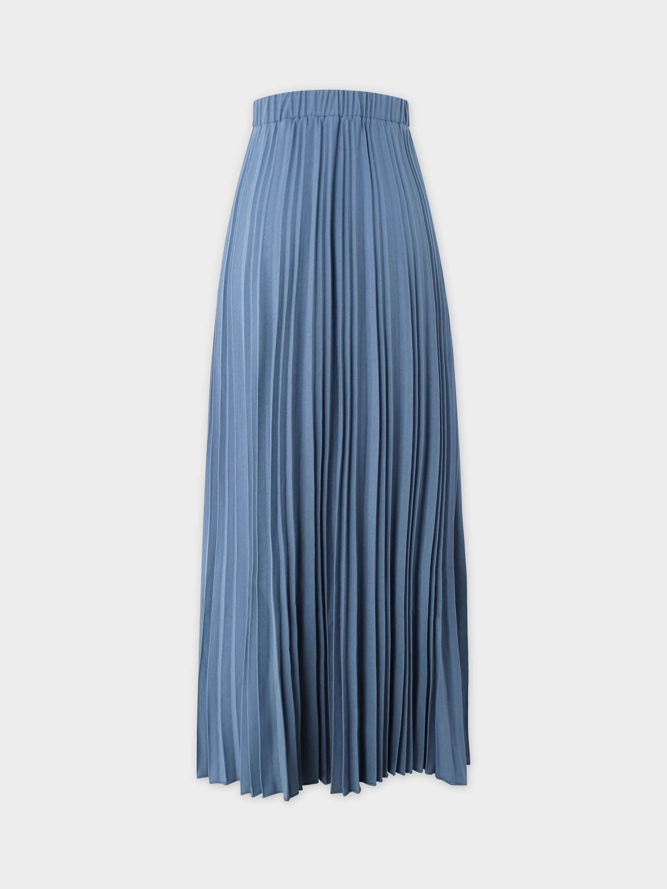 Blue pleated skirt on a light gray background
