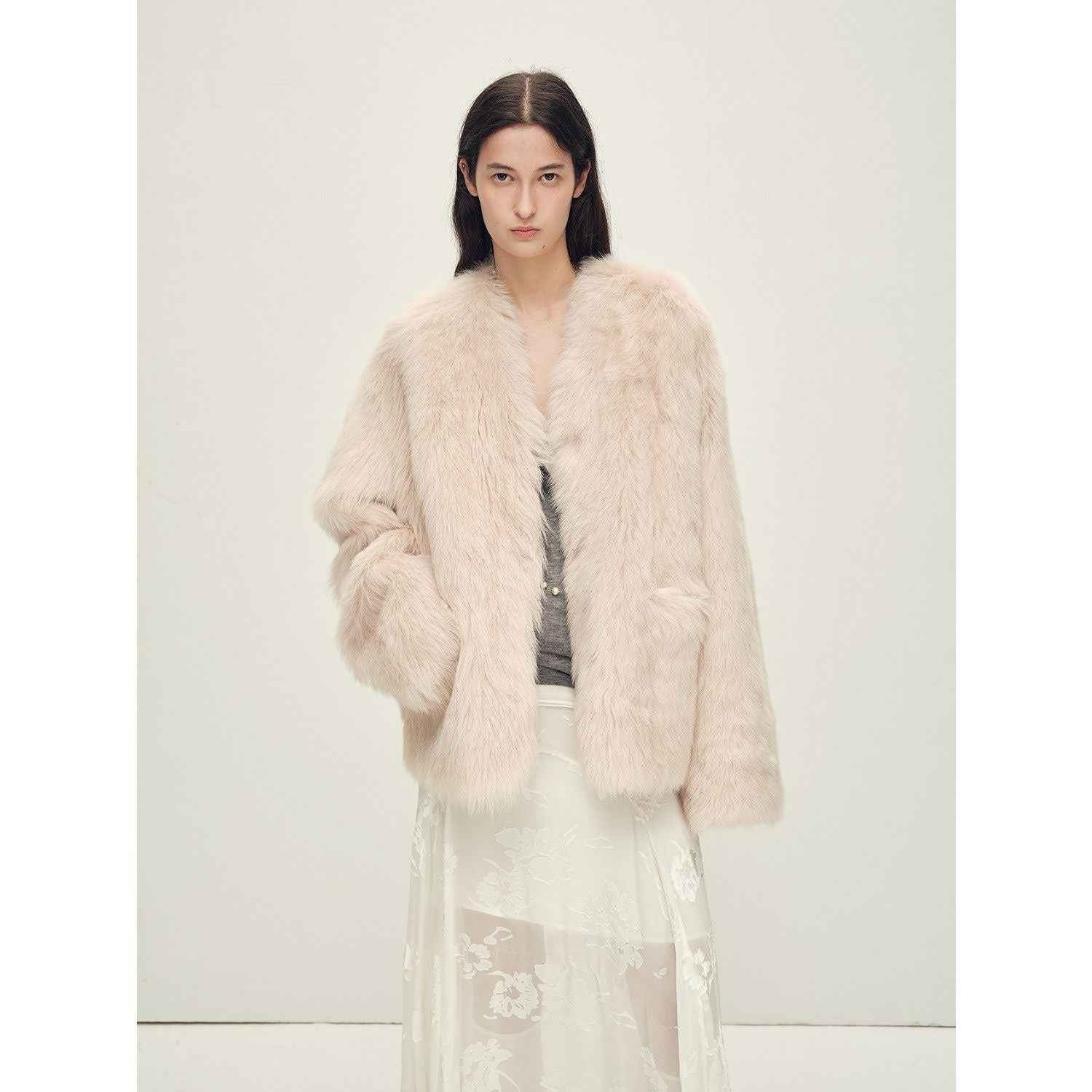 Woman wearing a light pink fur coat against a white background