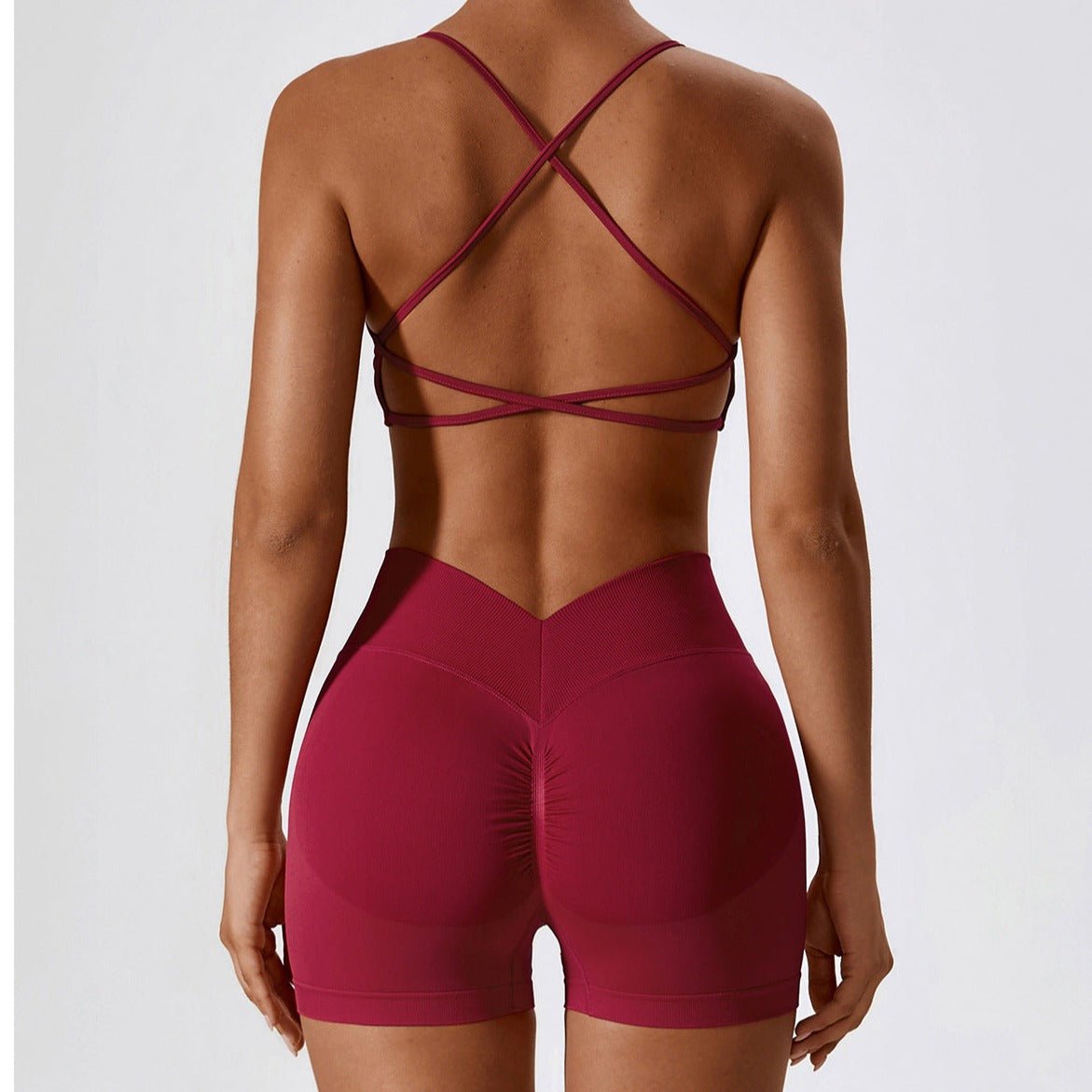 Maroon athletic outfit with criss-cross back design on a plain background