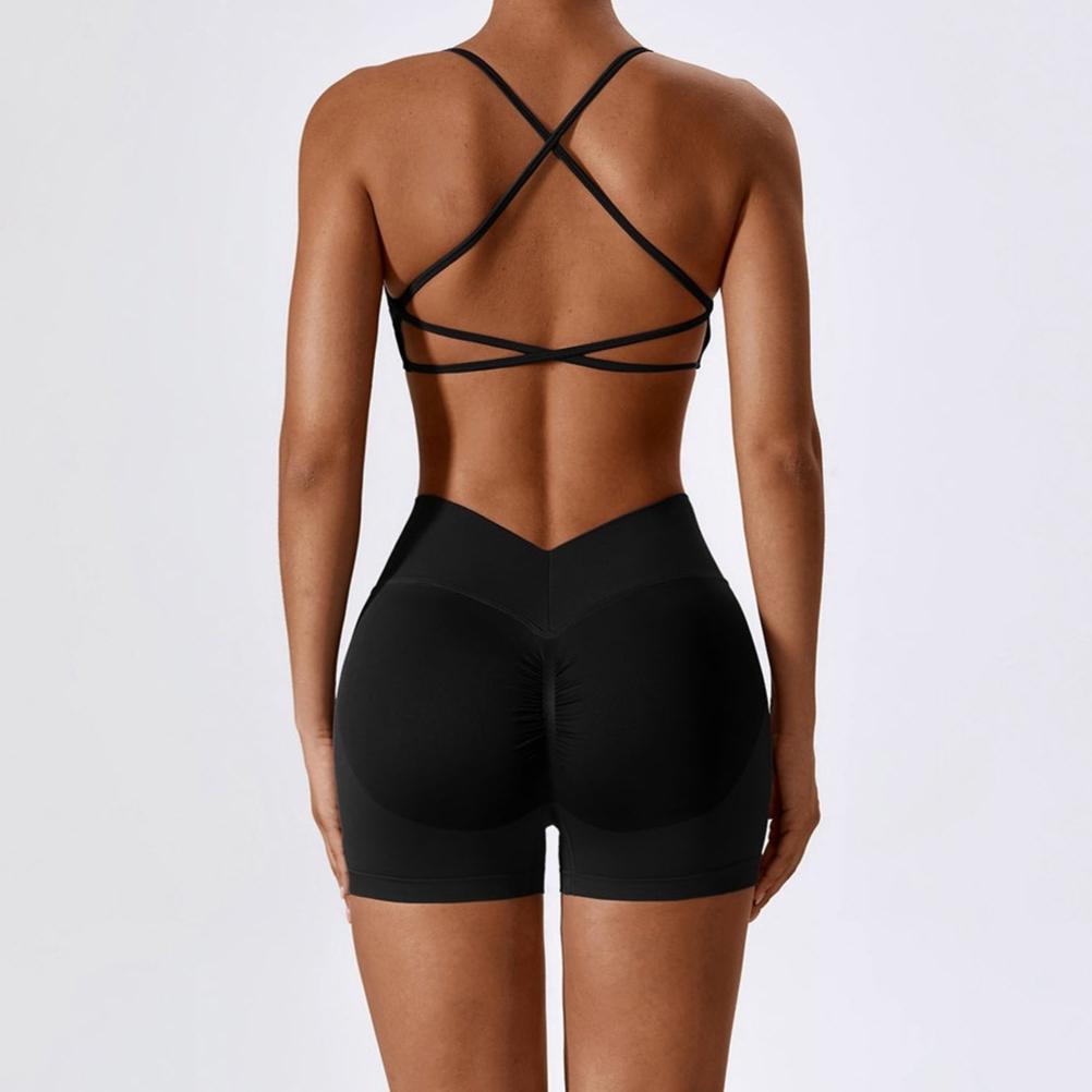 Black strappy top and shorts on a plain background