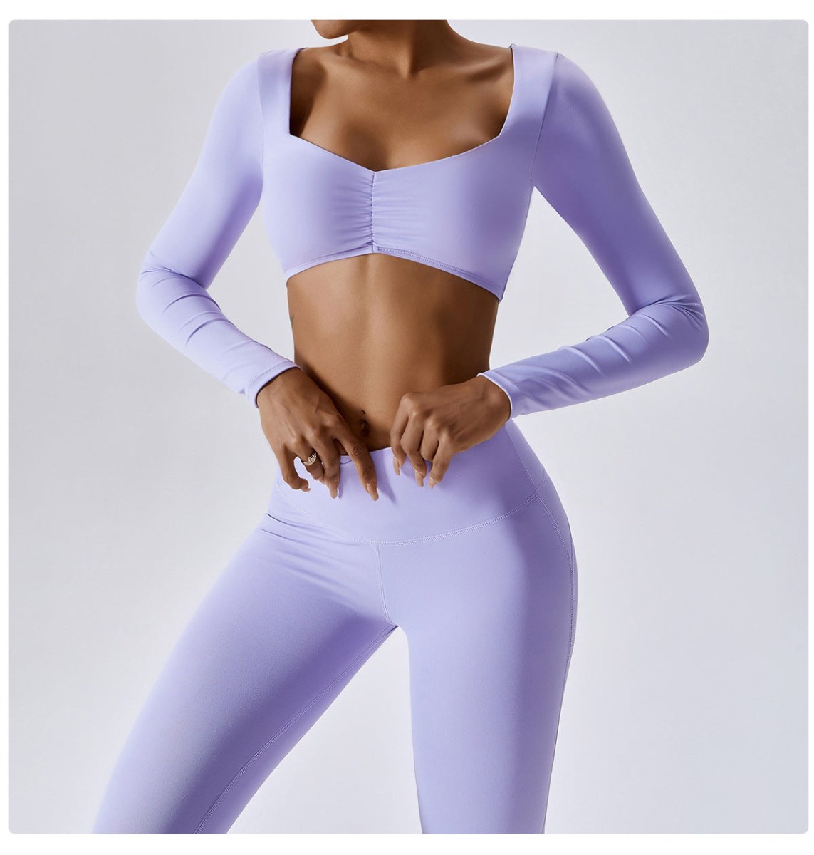 Person wearing a matching lavender sports bra and leggings set on a light gray background