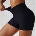 Person wearing black athletic shorts on a plain background